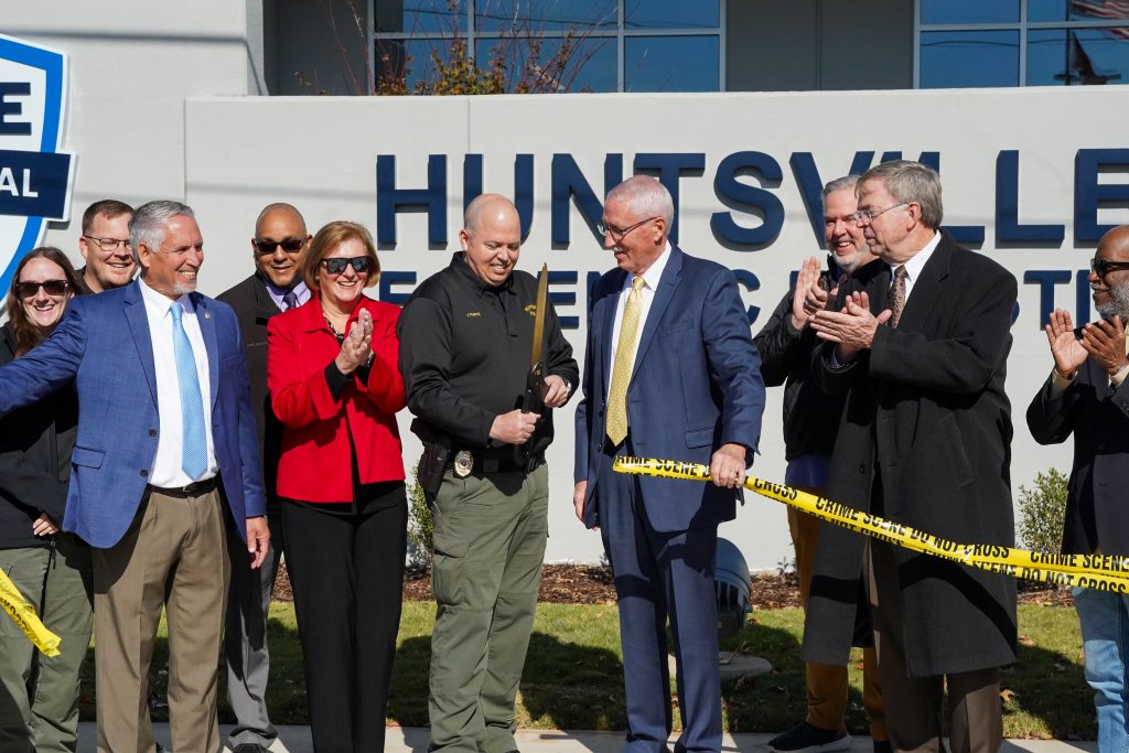 HPD Chief Kirk Giles, alongside Mayor Tommy Battle, City Council members and other HPD personnel cut the ribbon during a ceremony celebrating the construction completion of HPD's Crime Scene and Evidence Warehouse Complex.