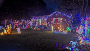 house with holiday lights and decorations at night