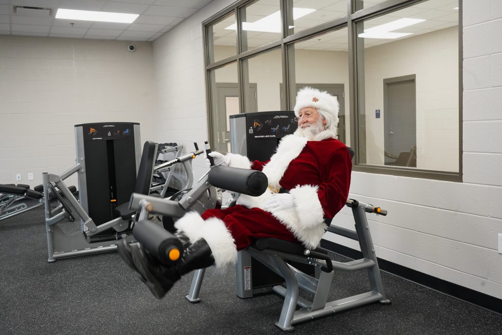 Santa Claus working out in weight room