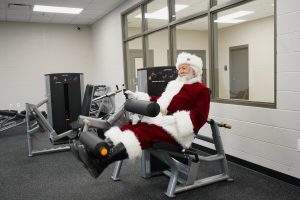 Santa Claus working out in weight room