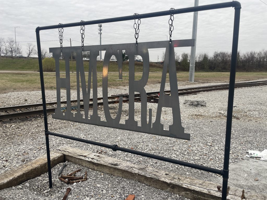 silhouetted HMCRA sign with railroad tracks in background