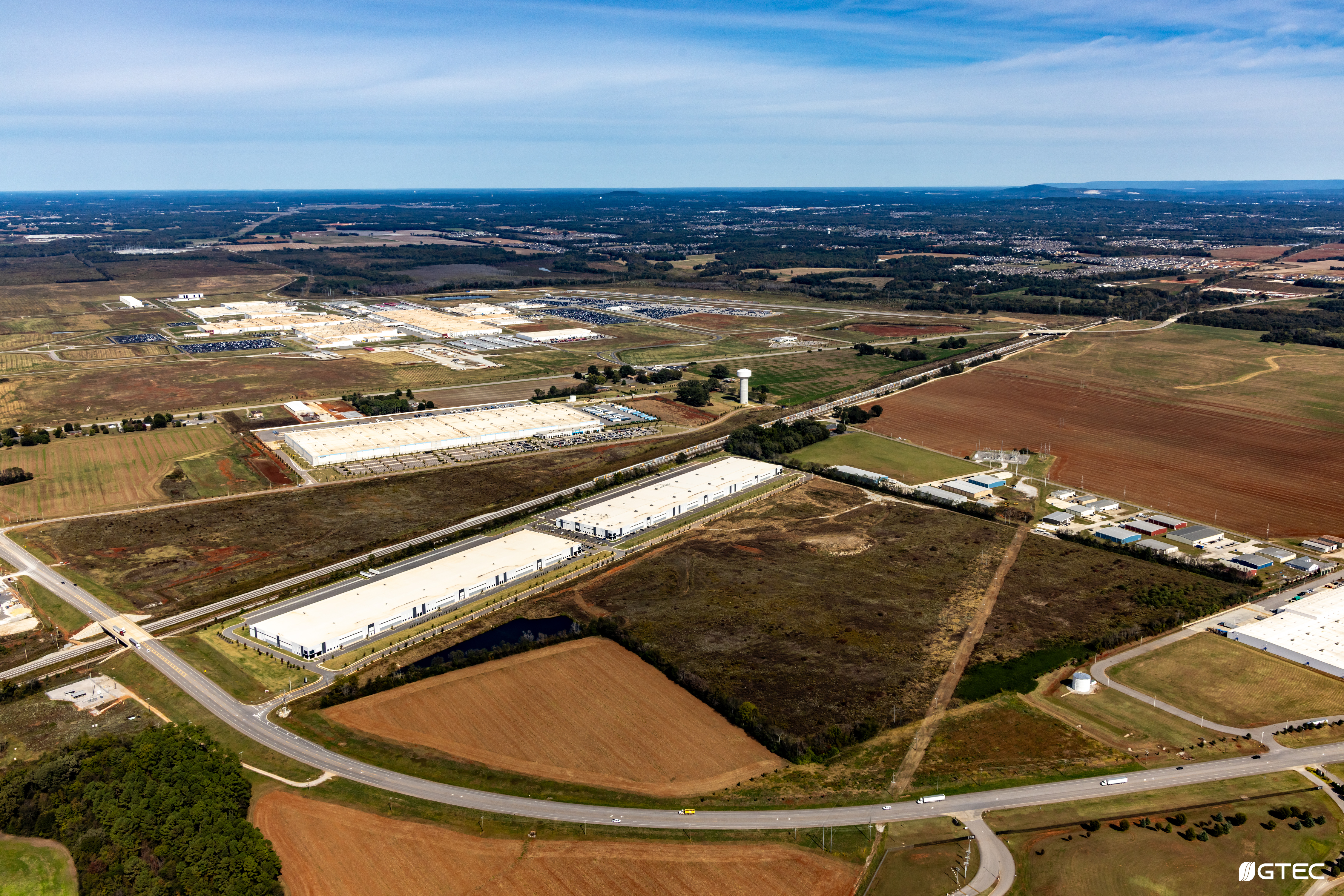 aerial photo of farmland and large manufacturing facilities