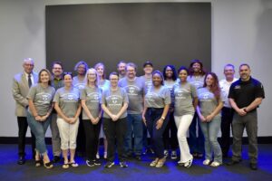 Members of the 2025 Huntsville Police Department Citizens Police Academy celebrate their graduation after completing the program.