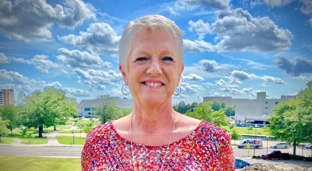 Joy McKee, the retired director of Huntsville Landscape Management smiles at the camera.