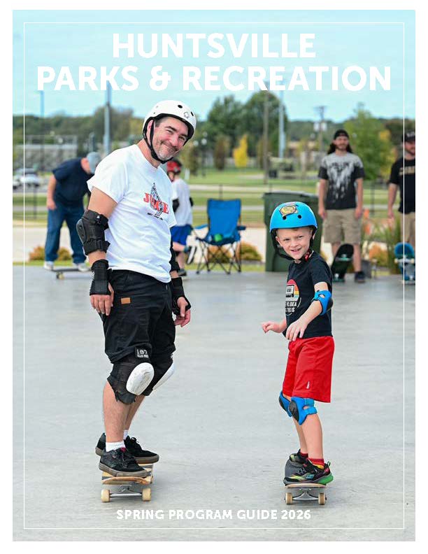 Man skateboarding alongside male child on skateboard, wearing helmets