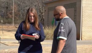 A woman from Huntsville Animal Services takes down information from a man during a community pet event