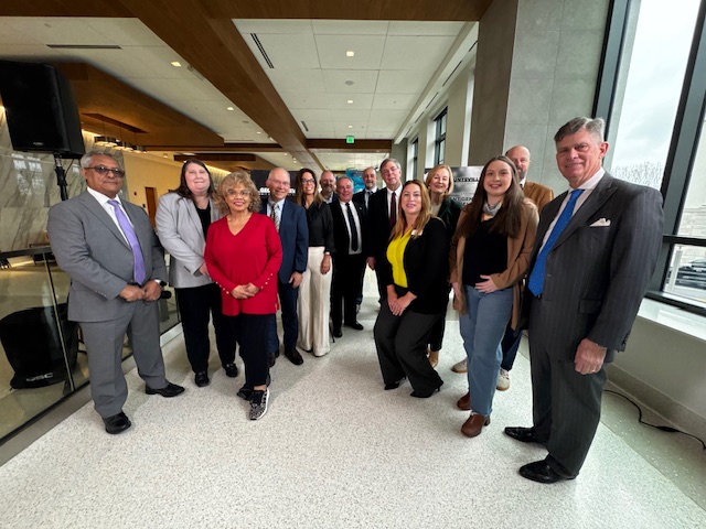 12 members of the GEOHuntsville Board of Directors, and Mayor Tommy Battle, gather for a group photo to promote the 2026 GEOHuntsville Summit.