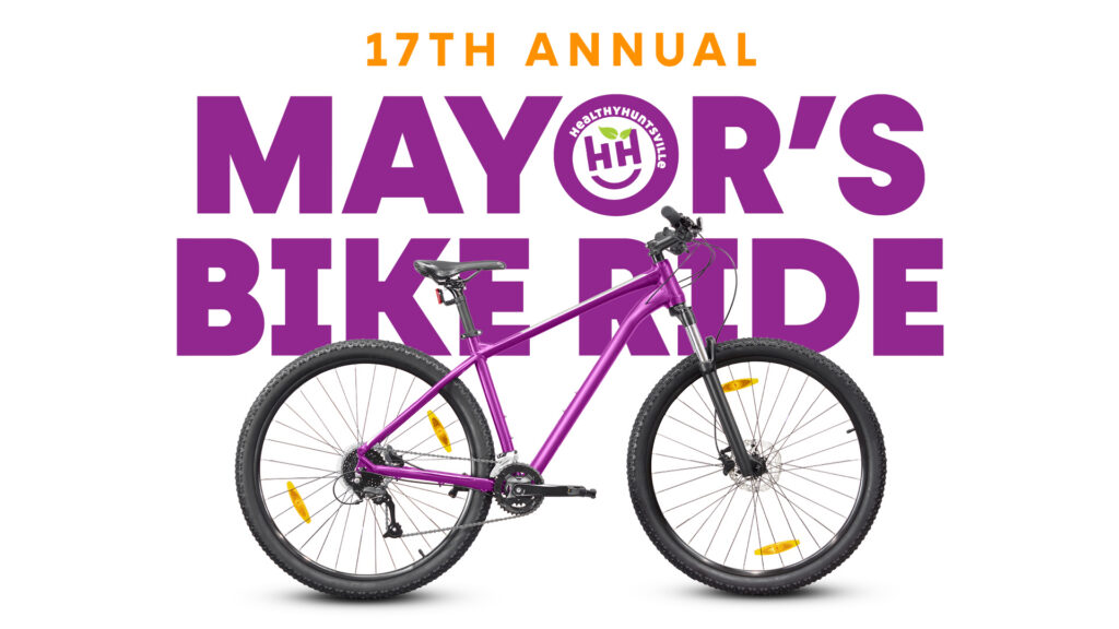 Promotional graphic for the 17th Annual Mayor’s Bike Ride. Large purple text reads 'Mayor’s Bike Ride' with a circular logo containing the Healthy Huntsville logo centered in the word 'Mayor’s.' A bright purple bicycle is displayed prominently in front of the text on a white background.
