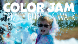Promotional graphic for the Color Jam Family Run & Walk featuring a child in sunglasses smiling and playing in blue-tinted foam. Large white text reads “COLOR JAM FAMILY RUN & WALK” over a colorful, foam-filled event scene.