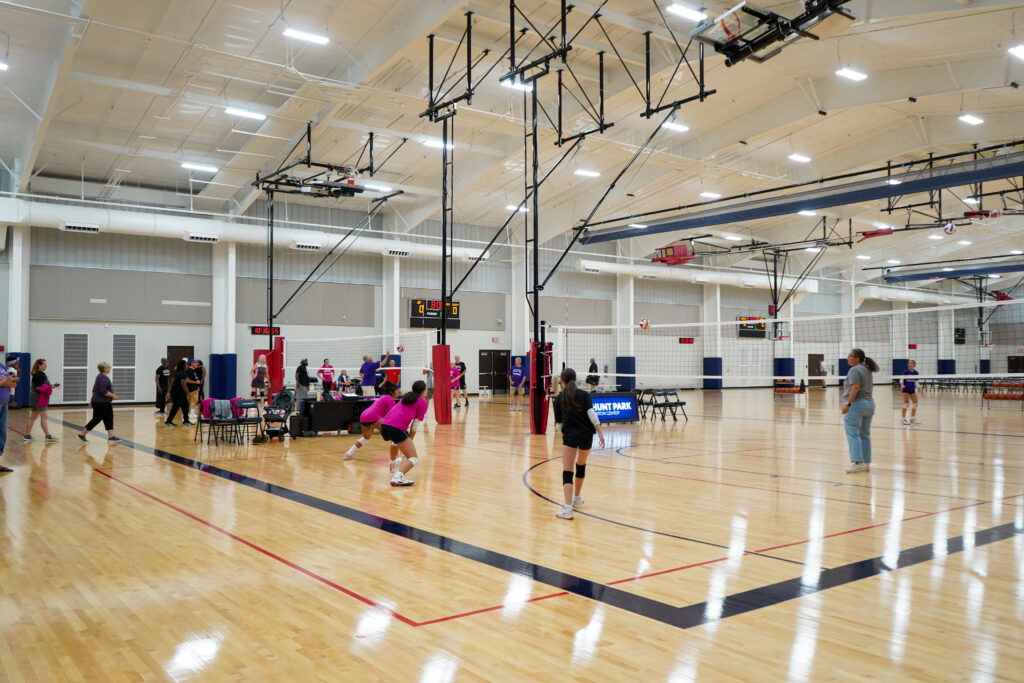 A group of people playing volleyball.