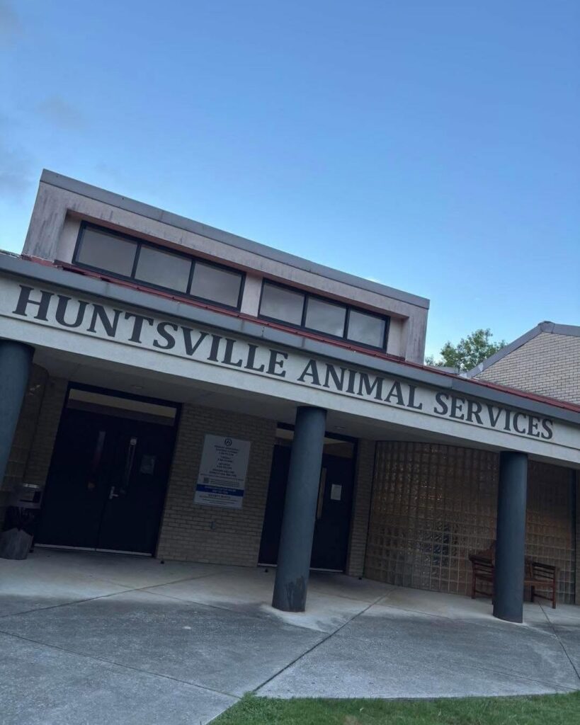 Photo of the front facade of the Huntsville Animal Services Building, a medium brown brick building.